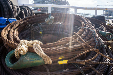 Coil of anchor penant wire rope on deck of a construction barge at oil field