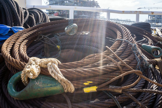 Coil of anchor penant wire rope on deck of a construction barge at oil field