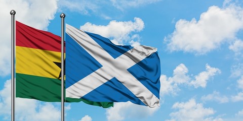 Ghana and Scotland flag waving in the wind against white cloudy blue sky together. Diplomacy concept, international relations.