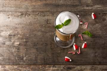 Peppermint coffee mocha for Christmas on wooden table. Copy space	
