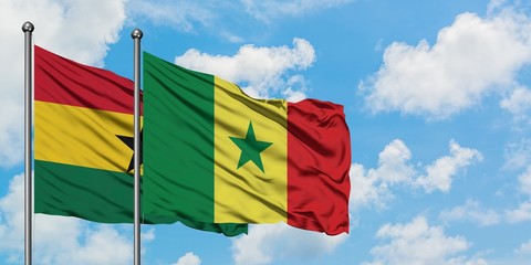 Ghana and Senegal flag waving in the wind against white cloudy blue sky together. Diplomacy concept, international relations.