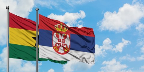 Ghana and Serbia flag waving in the wind against white cloudy blue sky together. Diplomacy concept, international relations.