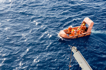 Obraz premium Emergency fast rescue craft deployed from a construction barge at oil field during a drill exercise 