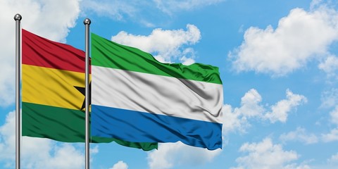 Ghana and Sierra Leone flag waving in the wind against white cloudy blue sky together. Diplomacy concept, international relations.