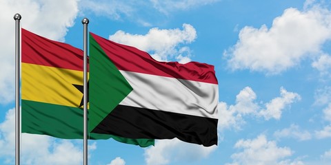 Ghana and Sudan flag waving in the wind against white cloudy blue sky together. Diplomacy concept, international relations.