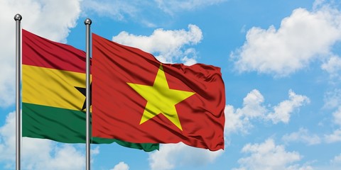 Ghana and Vietnam flag waving in the wind against white cloudy blue sky together. Diplomacy concept, international relations.