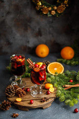 Fototapeta na wymiar Christmas mulled red wine with spices, cranberry and fruits. Traditional Christmas hot drink. Christmas drink background