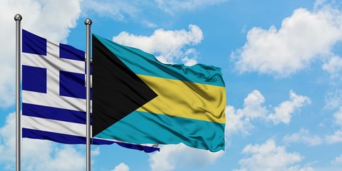 Greece and Bahamas flag waving in the wind against white cloudy blue sky together. Diplomacy concept, international relations.