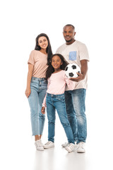 happy african american man holding soccer ball near smiling wife and daughter on white background