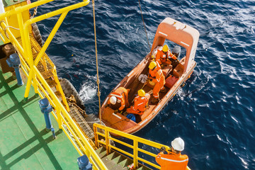 Obraz premium Fast rescue craft being deployed from a construction barge at oil field