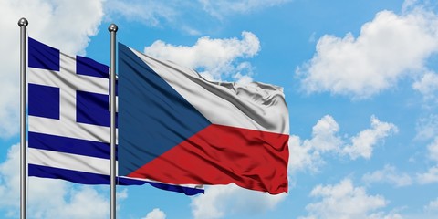 Greece and Czech Republic flag waving in the wind against white cloudy blue sky together. Diplomacy concept, international relations.