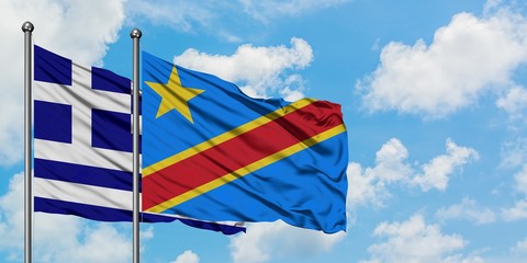 Greece and Congo flag waving in the wind against white cloudy blue sky together. Diplomacy concept, international relations.