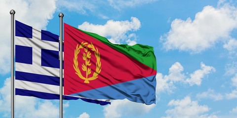 Greece and Eritrea flag waving in the wind against white cloudy blue sky together. Diplomacy concept, international relations.