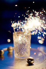 burning sparklers in vintage glass vase