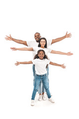 Fototapeta na wymiar cheerful african american kid with parents imitating flying with outstretched hands on white background
