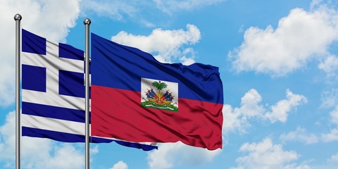 Greece and Haiti flag waving in the wind against white cloudy blue sky together. Diplomacy concept, international relations.