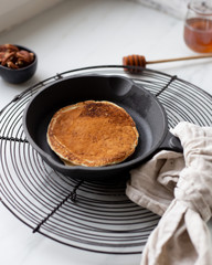 Pancakes with banana, walnuts and honey. Morning concept