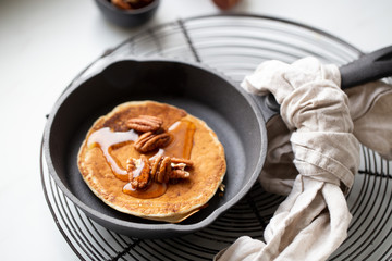Pancakes with banana, walnuts and honey. Morning concept