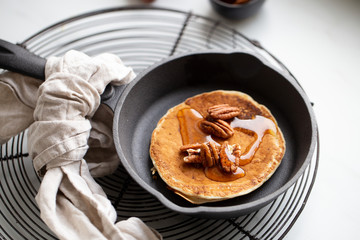 Pancakes with banana, walnuts and honey. Morning concept