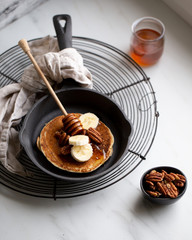 Pancakes with banana, walnuts and honey. Morning concept