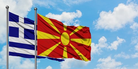 Greece and Macedonia flag waving in the wind against white cloudy blue sky together. Diplomacy concept, international relations.