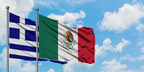 Greece and Mexico flag waving in the wind against white cloudy blue sky together. Diplomacy concept, international relations.