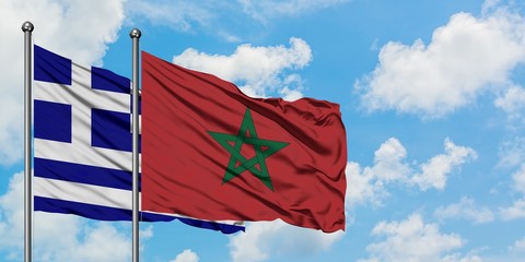 Greece and Morocco flag waving in the wind against white cloudy blue sky together. Diplomacy concept, international relations.