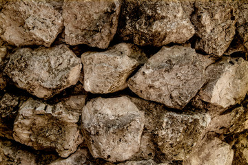 A wall of old stones. Background of rough large stones.