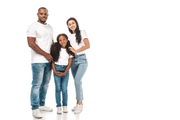 happy african american father, mother and daughter hugging and smiling at camera on white background