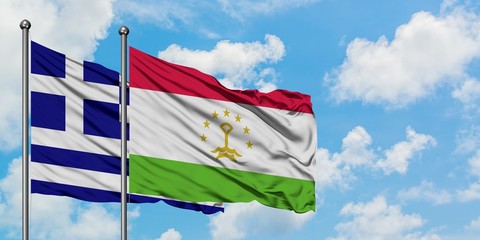 Greece and Tajikistan flag waving in the wind against white cloudy blue sky together. Diplomacy concept, international relations.