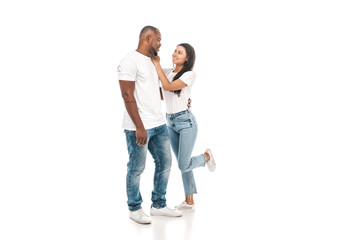 cheerful african american woman touching face of handsome husband on white background