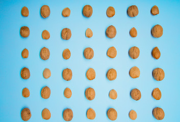 Still life with nuts and almonds on blue background