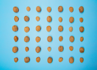 Still life with nuts and almonds on blue background