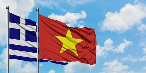 Greece and Vietnam flag waving in the wind against white cloudy blue sky together. Diplomacy concept, international relations.