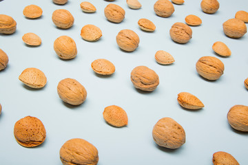 Still life with nuts and almonds on blue background