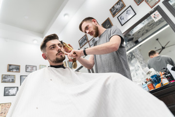 Fototapeta premium Haircut and beard haircut in barbershop. Man haircut