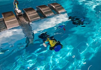 Rescue training. Simulation. Diving. Escape from airplane. Under water.