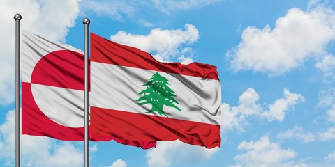 Greenland and Lebanon flag waving in the wind against white cloudy blue sky together. Diplomacy concept, international relations.