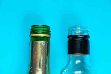 empty bottle of alcoholic drink on isolated blue background