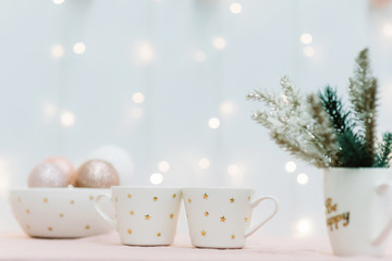 Two cups for christmas cacao with marshmellous, golden stars, new year tree, scandinavian kitchen, festive background