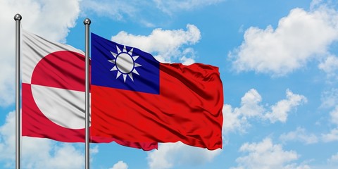 Greenland and Taiwan flag waving in the wind against white cloudy blue sky together. Diplomacy concept, international relations.