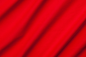 Fragment of crumpled red polyester fabric