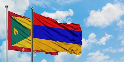 Grenada and Armenia flag waving in the wind against white cloudy blue sky together. Diplomacy concept, international relations.