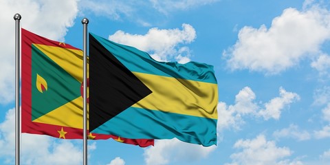 Grenada and Bahamas flag waving in the wind against white cloudy blue sky together. Diplomacy concept, international relations.