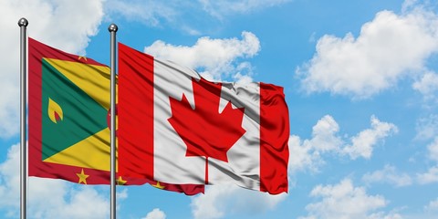 Grenada and Canada flag waving in the wind against white cloudy blue sky together. Diplomacy concept, international relations.