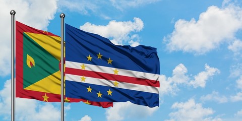 Grenada and Cape Verde flag waving in the wind against white cloudy blue sky together. Diplomacy concept, international relations.