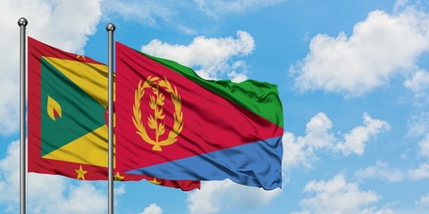 Grenada and Eritrea flag waving in the wind against white cloudy blue sky together. Diplomacy concept, international relations.