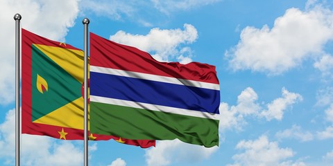 Grenada and Gambia flag waving in the wind against white cloudy blue sky together. Diplomacy concept, international relations.