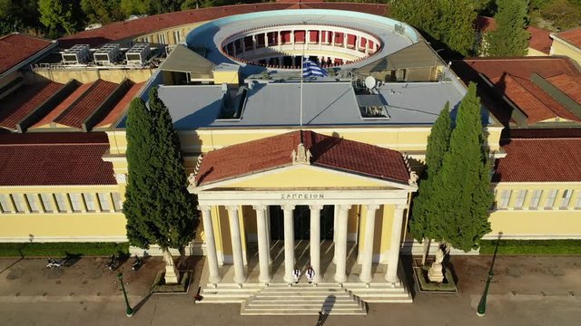 Aerial drone video of renovated public neoclassic building facade of Zappeion used for events and meetings in the National Gardens of Athens, Greece