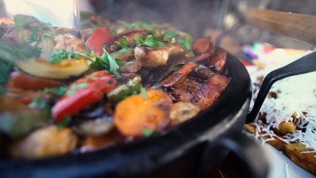 Bulgarian traditional cuisine. Sach of mixed meats and vegetables on wooden background